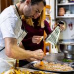 Team cooking aziendale: partecipante in cucina durante la sfida con lo chef